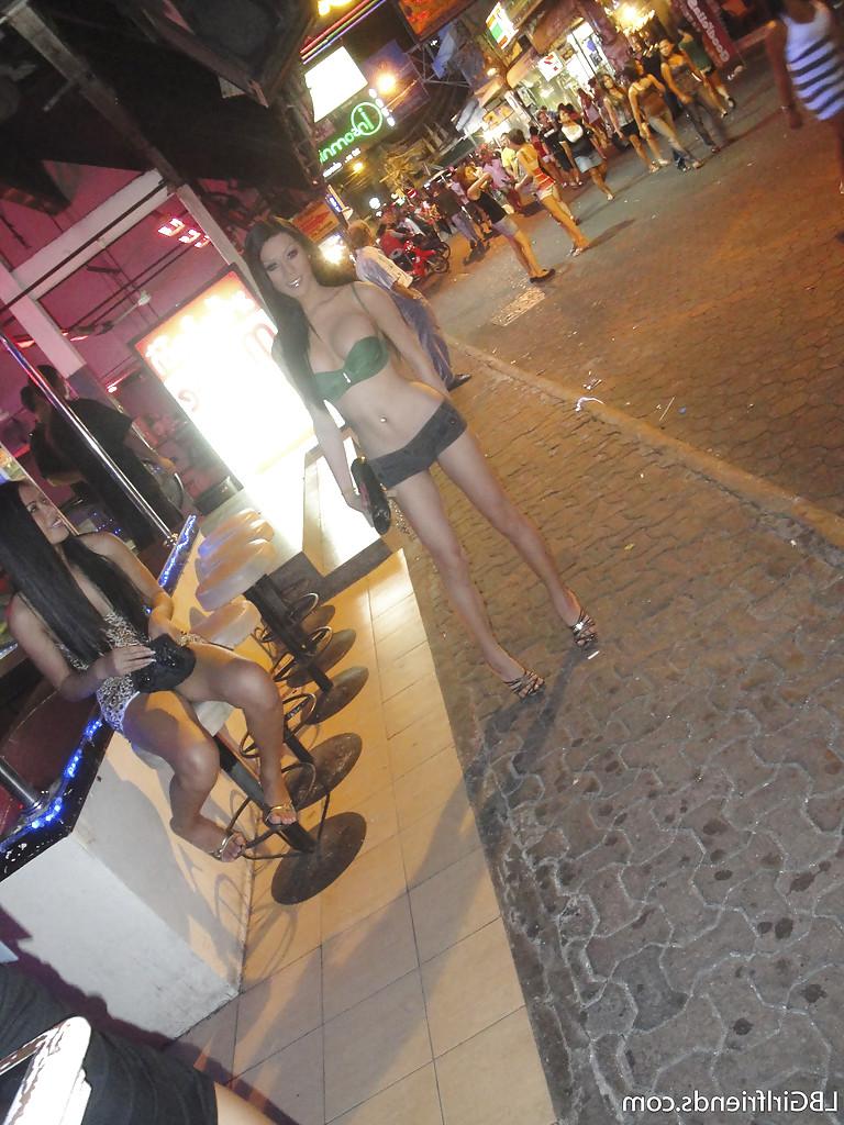 16P Sexy Thai shemale Army shows off her big tranny tits on public street
