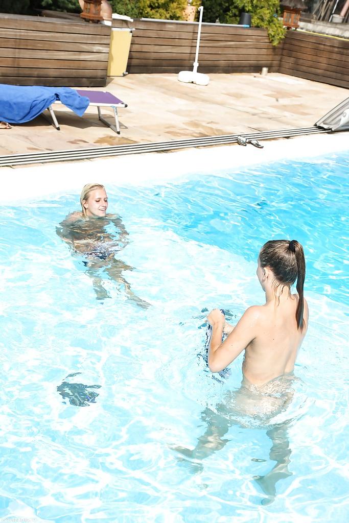 16P Topless blonde Sara J seduces her teen girlfriend into lesbian sex in pool