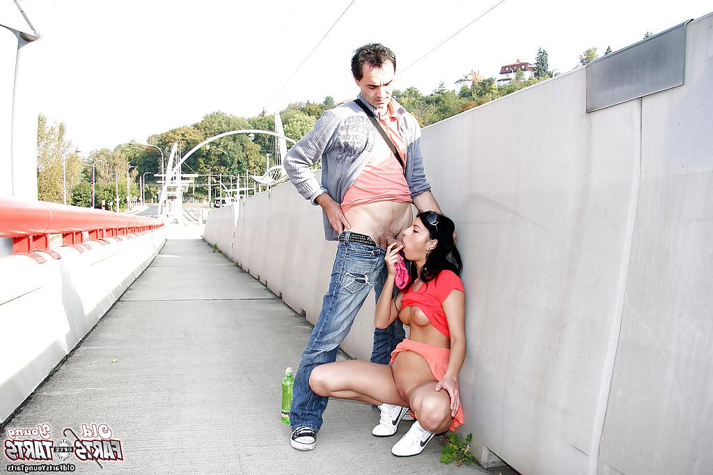 16P Young brunette slut sucks off an older man on public walkway
