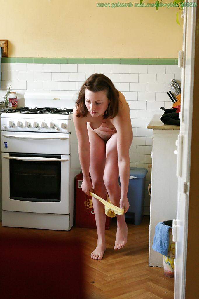 16P Hidden camera catches nude girl getting dressed in the kitchen