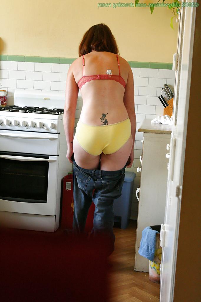 16P Hidden camera catches nude girl getting dressed in the kitchen