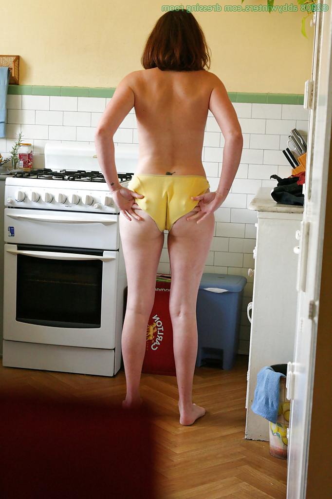 16P Hidden camera catches nude girl getting dressed in the kitchen