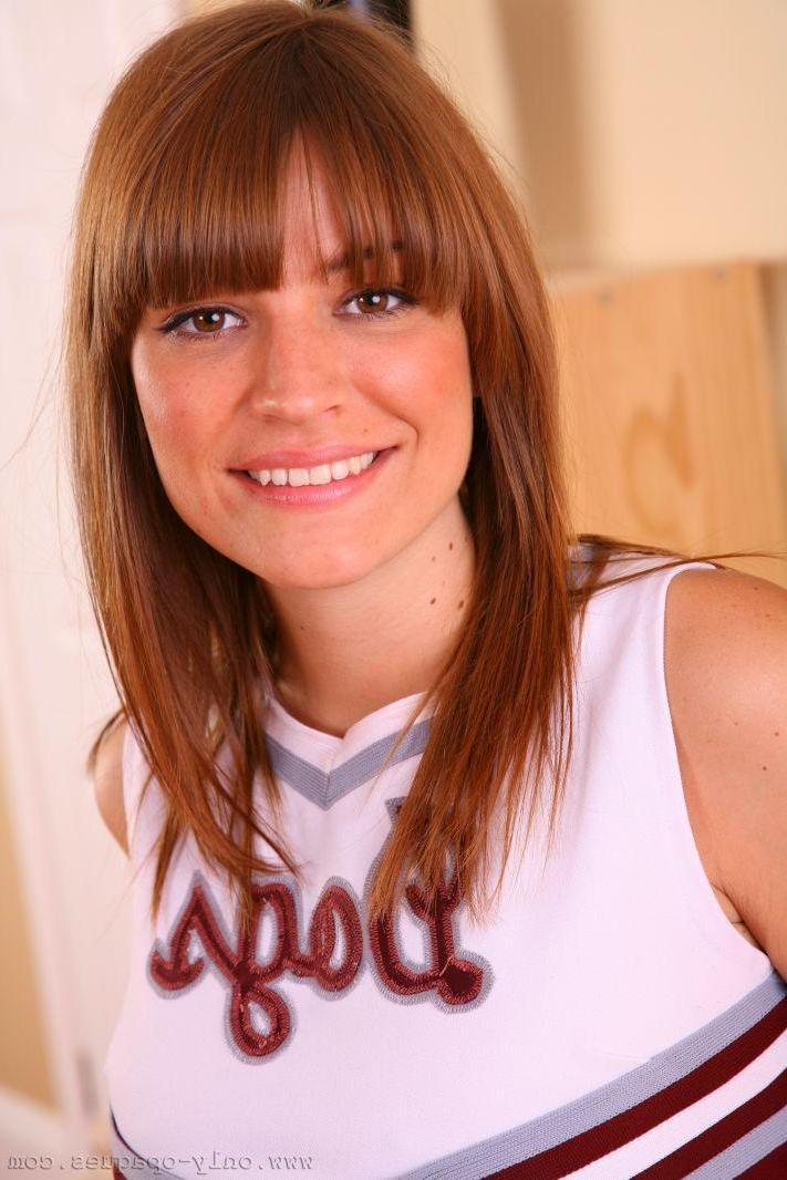 16P Amy P looks perfect posing in her cheerleader uniform on her sofa.