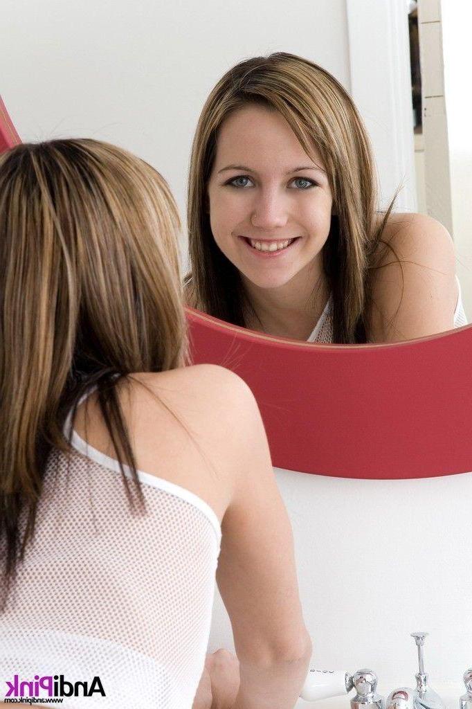 20P Pictures of teen model Andi Pink stripping in the bathroom