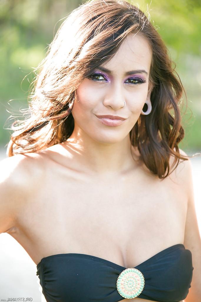 16P Lascivious young babe Janice Griffith poses outdoors in her bikini