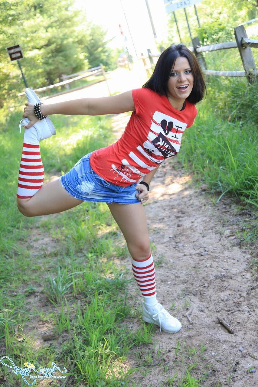 15P Pictures of Ann Angel being a cock-tease outdoors in a short jean miniskirt