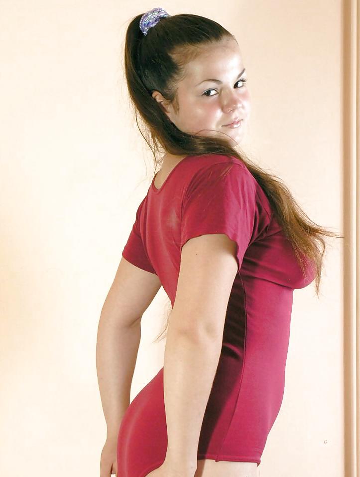 20P Teeny brunette showing off her big titties