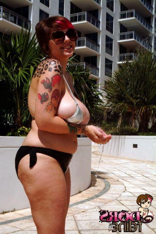 16P Pictures of Dors Feline trying to keep her massive jugs in a small bikini