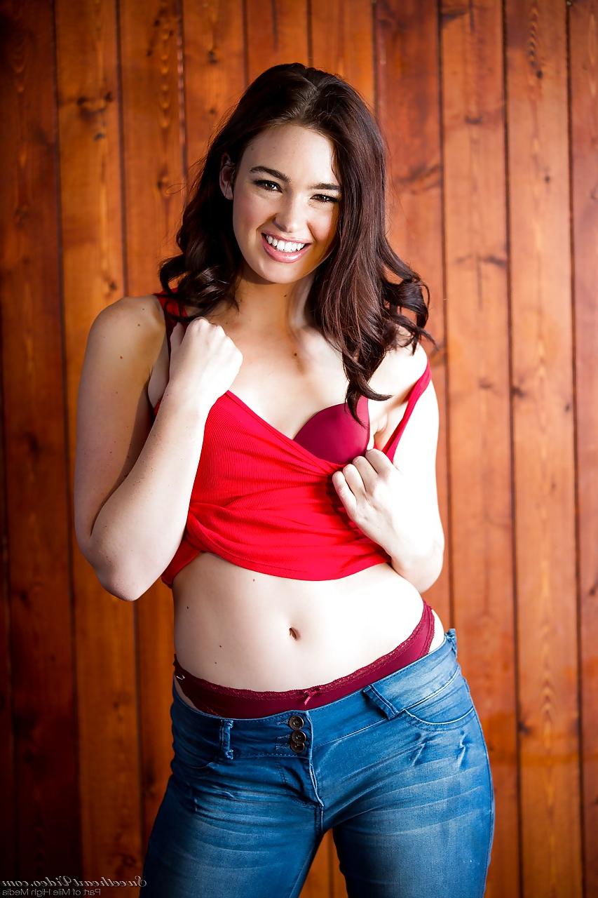 15P Brunette Jodi Taylor in jeans undressing to show hard nipples & bald pussy