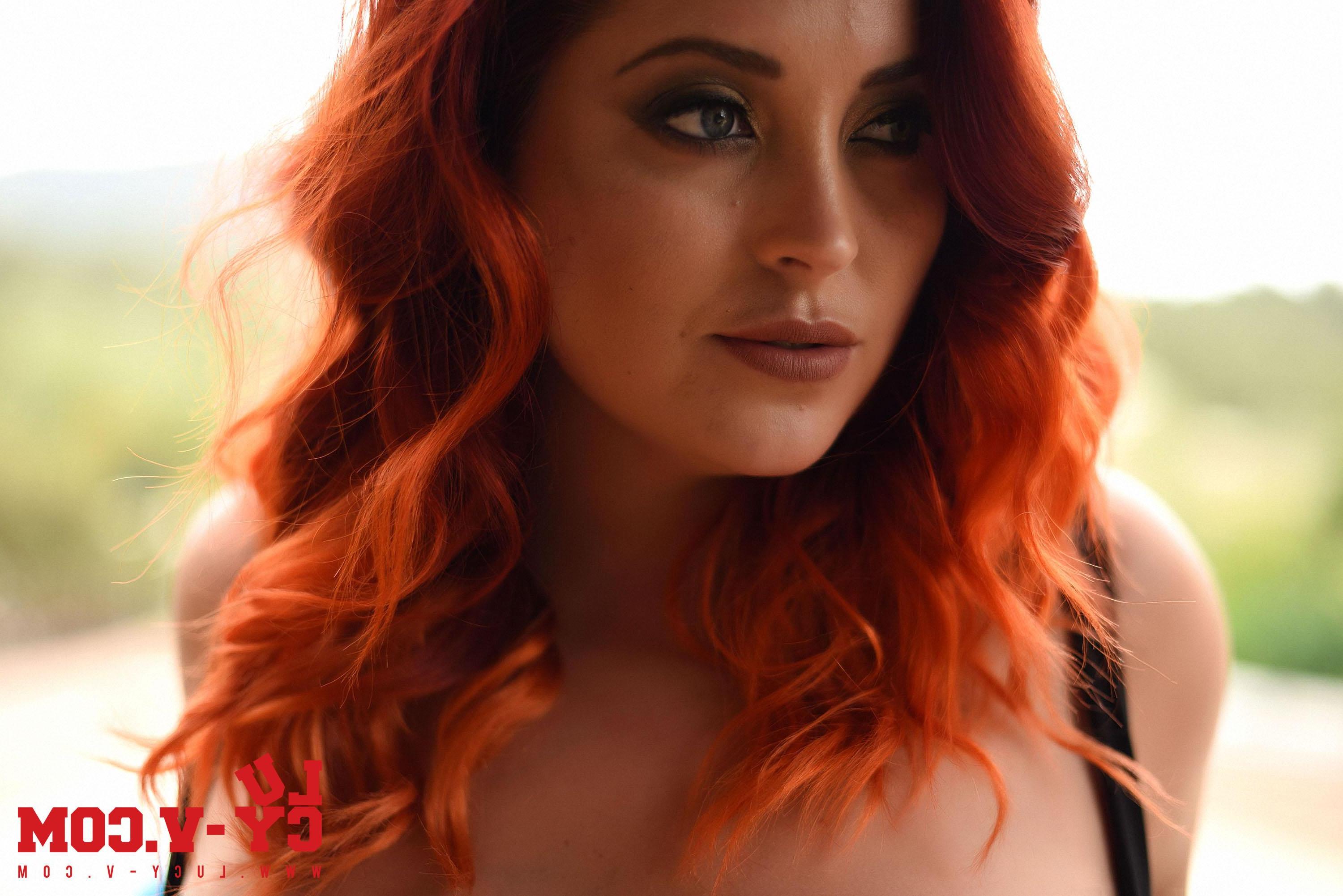16P Curvy redhead Lucy V poses in her sexy black bodysuit