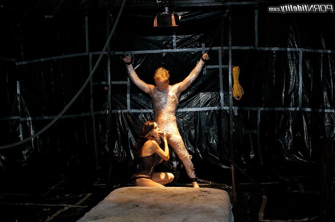 16P McKenzie Lee blows Ryan while he's bound then fucks him in a dirty warehouse.