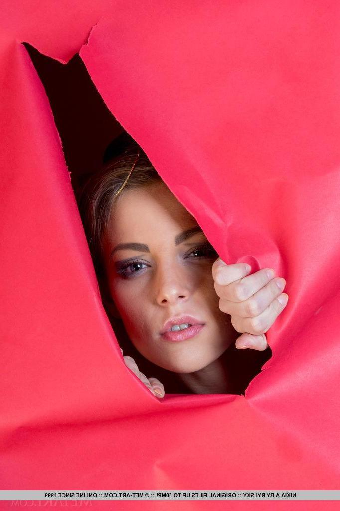 18P An artistic photo shoot with Nikia A posing naked against a bright red torn wallpaper