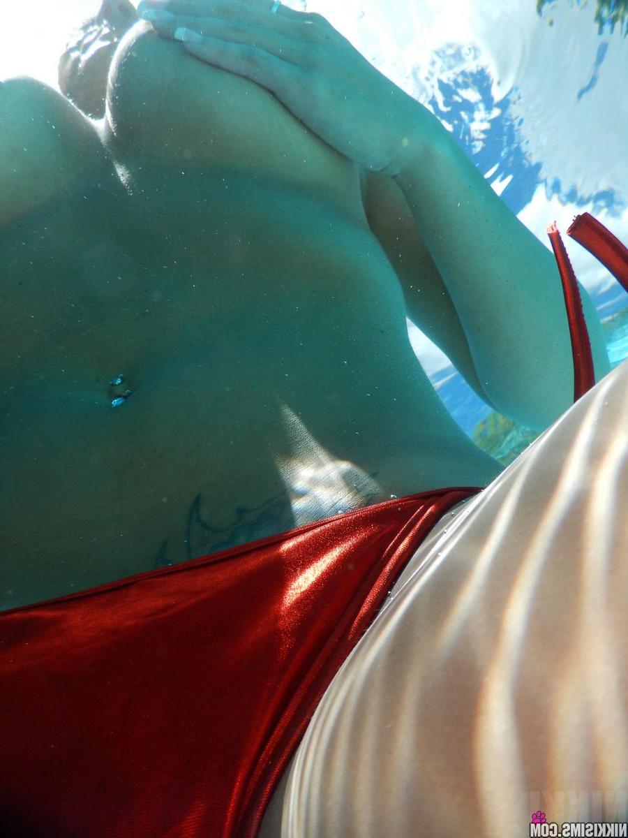 15P Busty hottie Nikki Sims falls out of her red bikini in the pool