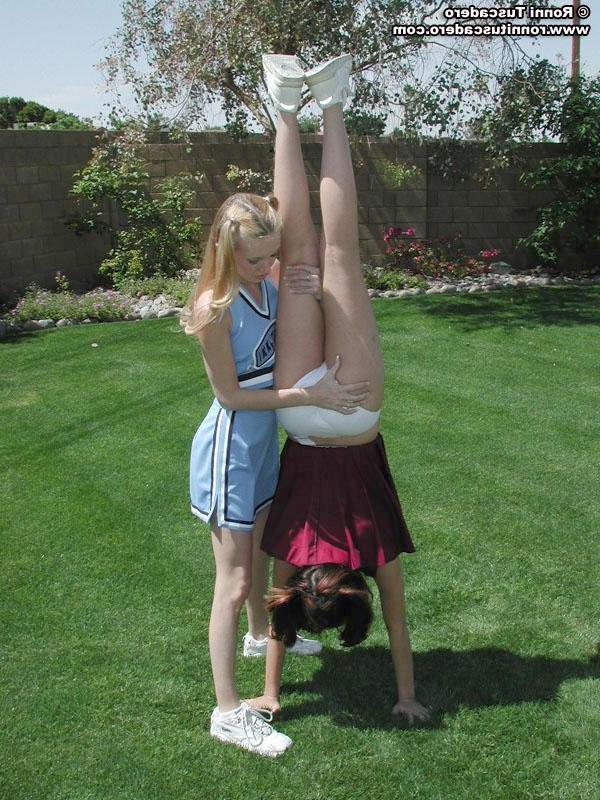 20P Pictures of two teen cheerleaders practicing their moves outside