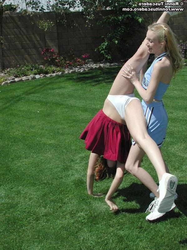 20P Pictures of two teen cheerleaders practicing their moves outside