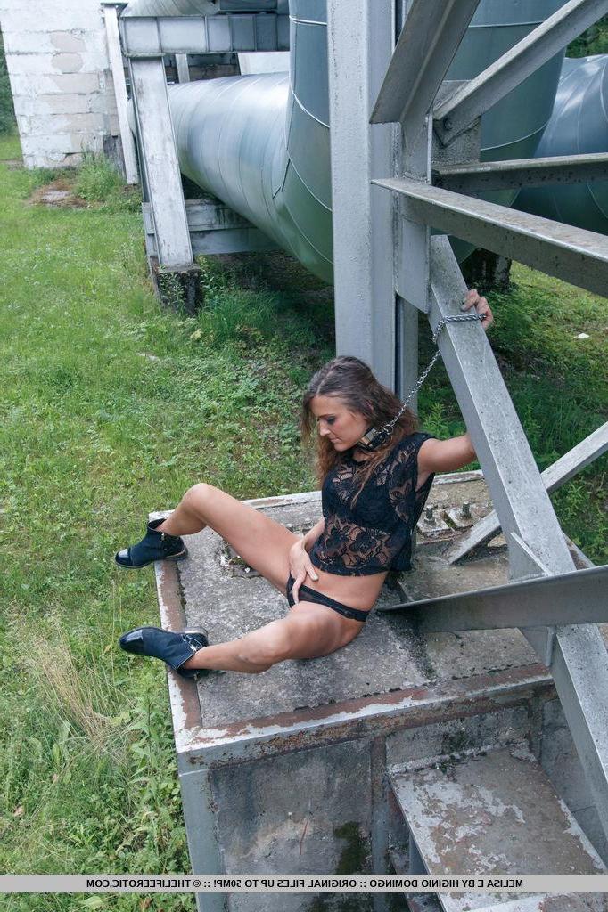 16P Brunetet babe Melisa E chains herself up outside