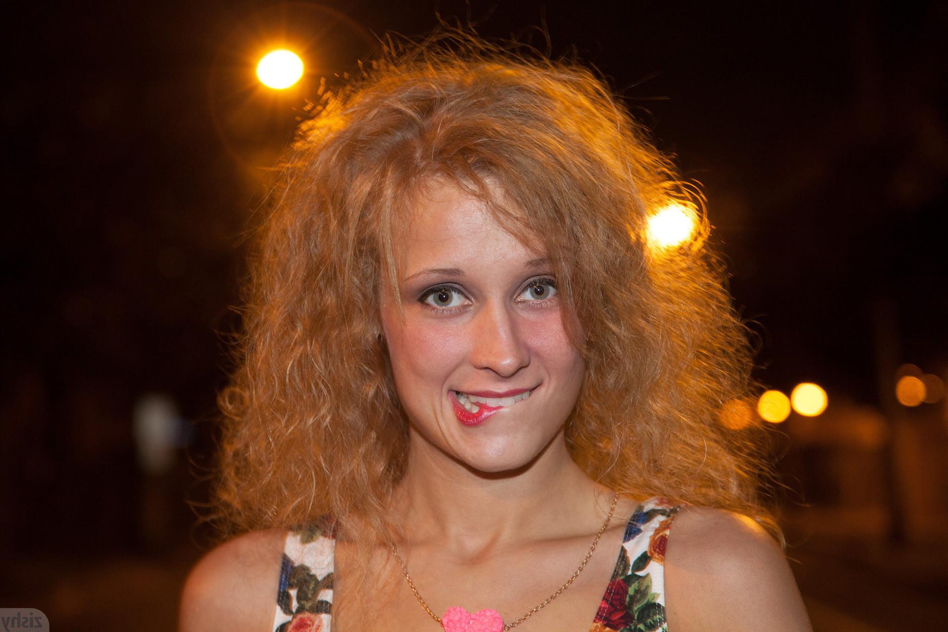 12P Rebel girl with curly hair smoking under a no smoking sign