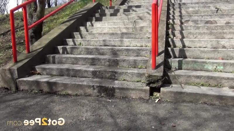 15P Dark haired girl pisses on concrete steps