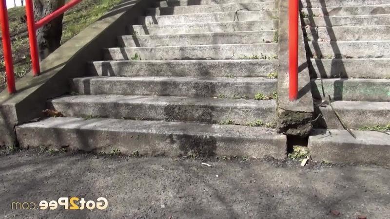 15P Dark haired girl pisses on concrete steps