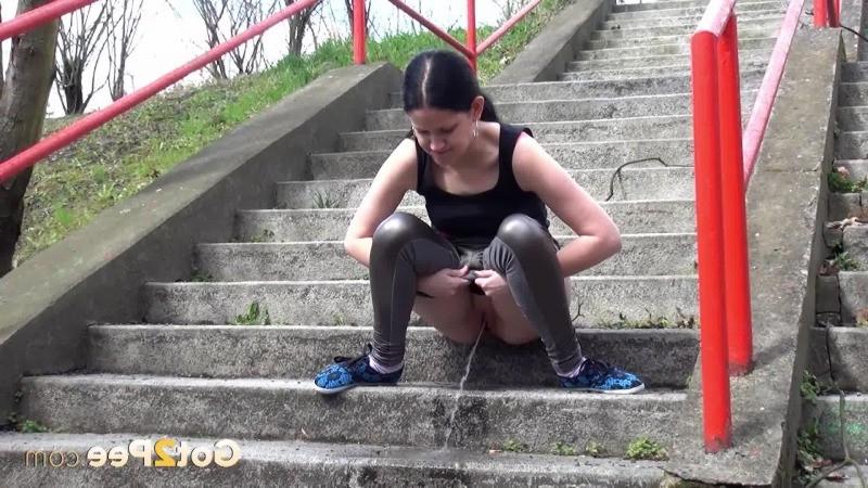 15P Dark haired girl pisses on concrete steps