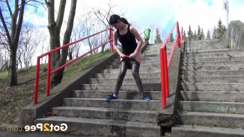 15P Dark haired girl pisses on concrete steps