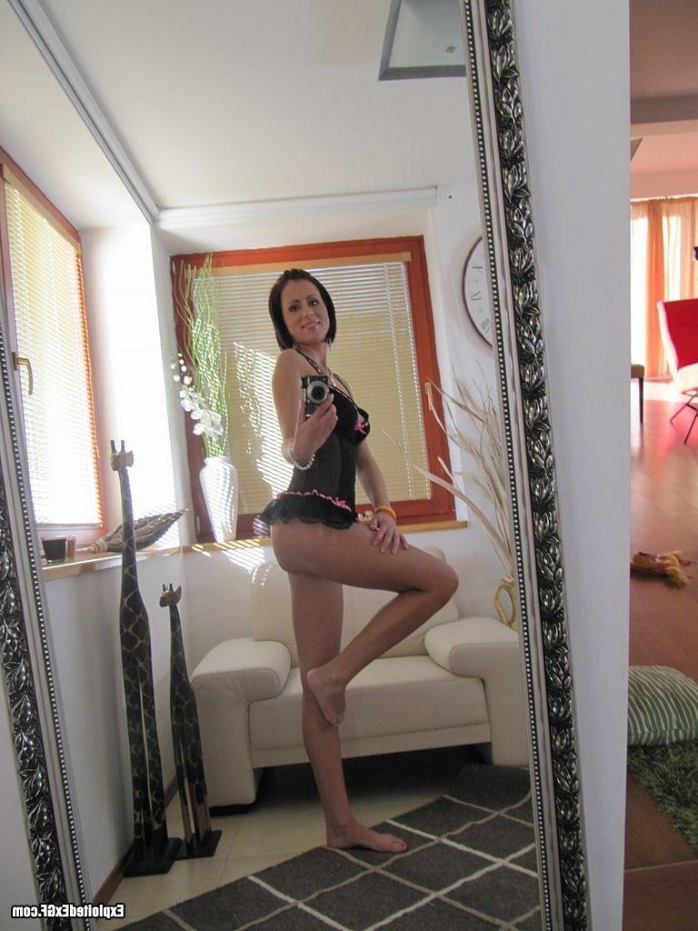15P Horny amateur chick stripping in her kitchen