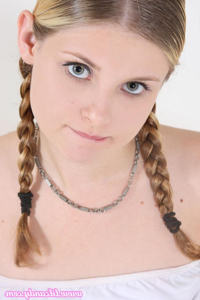 16P Lil' Candy sports a set of braided pigtails while she spreads her tight pussy