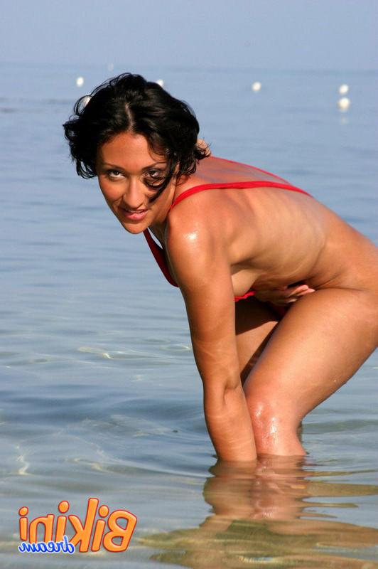 15P Babe wades in the ocean in her red sling bikini