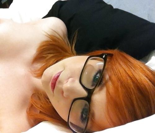 20P A beautiful young red-haired girl with glasses