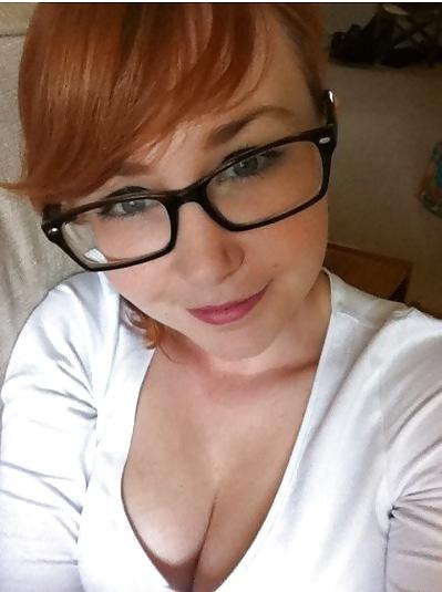20P A beautiful young red-haired girl with glasses