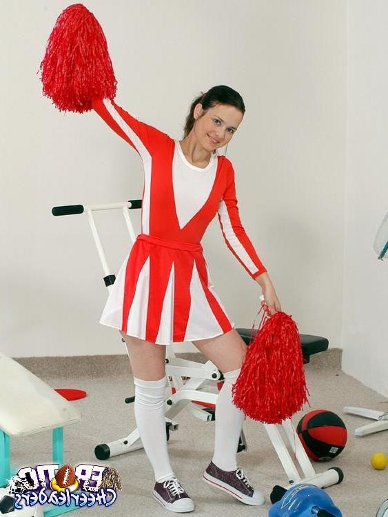 15P Innocent looking brunette cheerleader rubbing her pink cunt in the gym