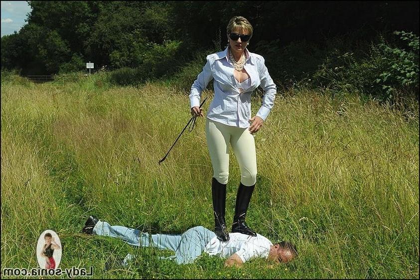 15P Kinky mistress in riding boots dominates slave guy outdoors
