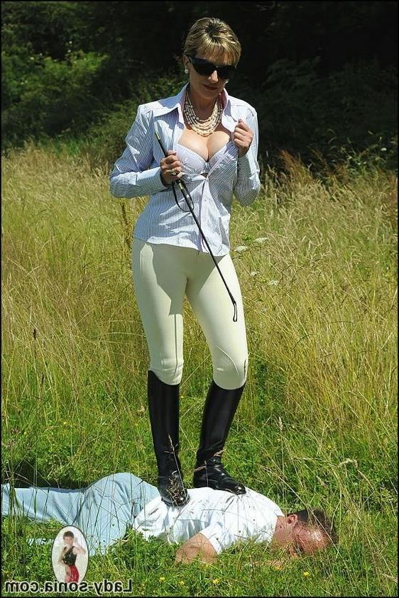 15P Kinky mistress in riding boots dominates slave guy outdoors