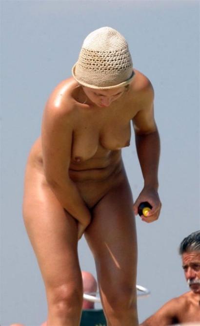 15P Sexy short haired nudist rubs her own naked body