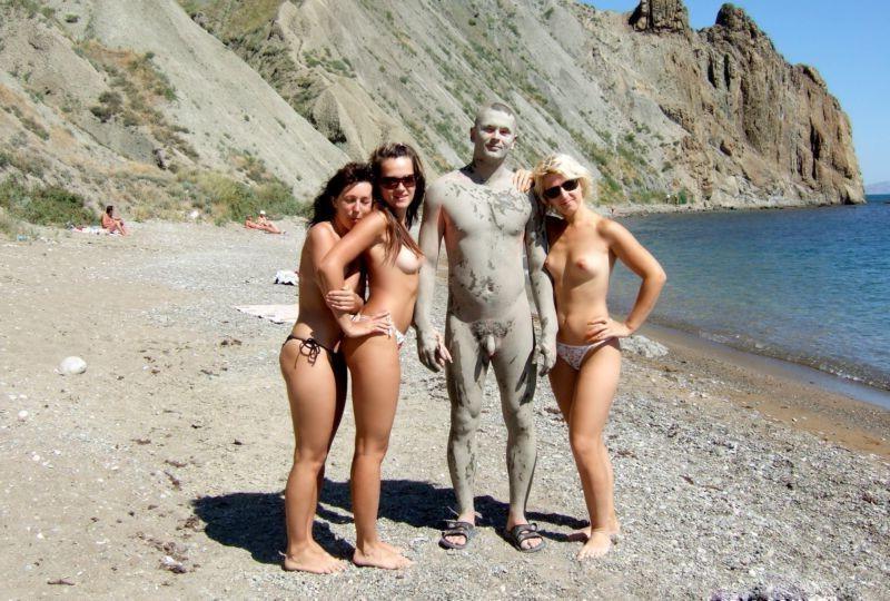 15P Long haired hottie lays around nude at the beach