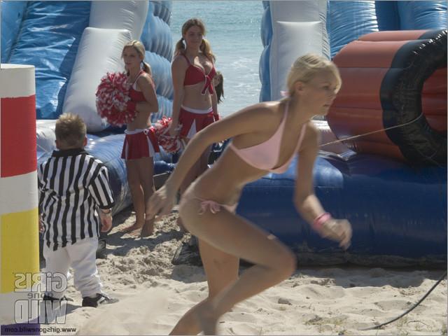 15P Busty young sluts in bikinis on the beach showing it all