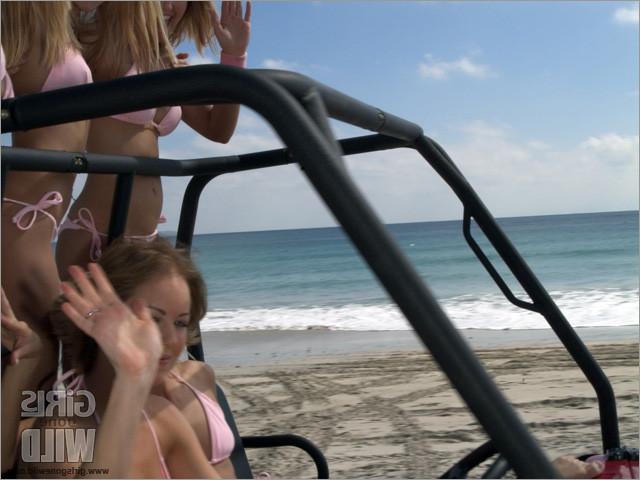 10P College babes in bikinis driving a buggy on the beach