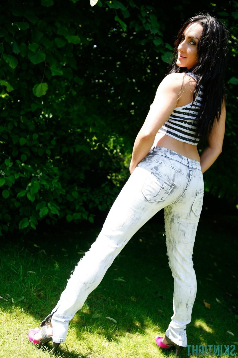 12P Hot brunette Chloe poses in her tight jeans outside