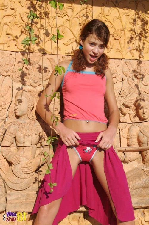17P Young beautiful curly redhead babe pulling down all her garments