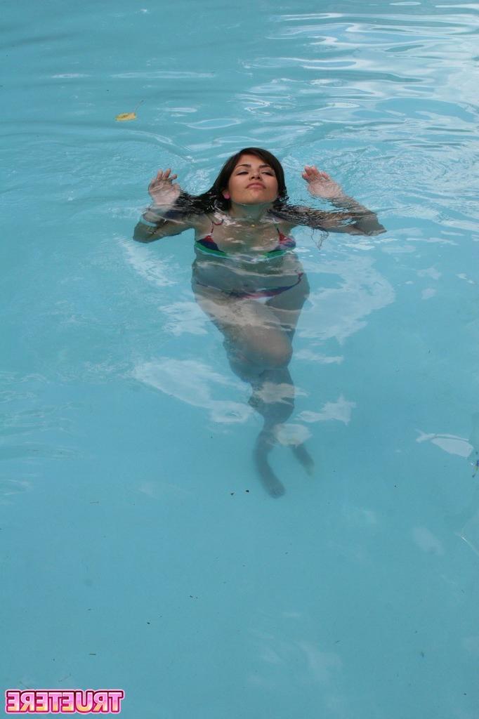 16P Bikini teen girl swimming in pool