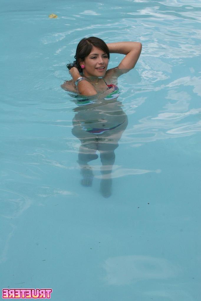 16P Bikini teen girl swimming in pool