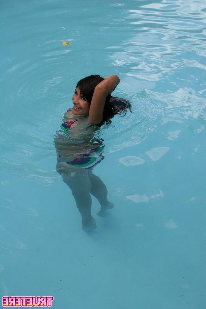 16P Bikini teen girl swimming in pool