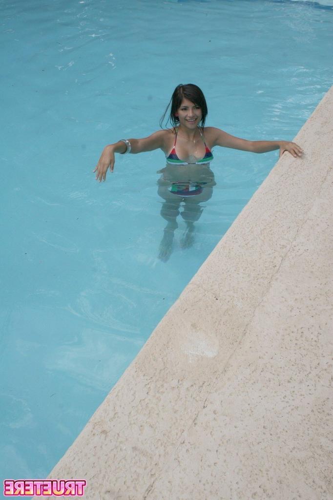 16P Bikini teen girl swimming in pool
