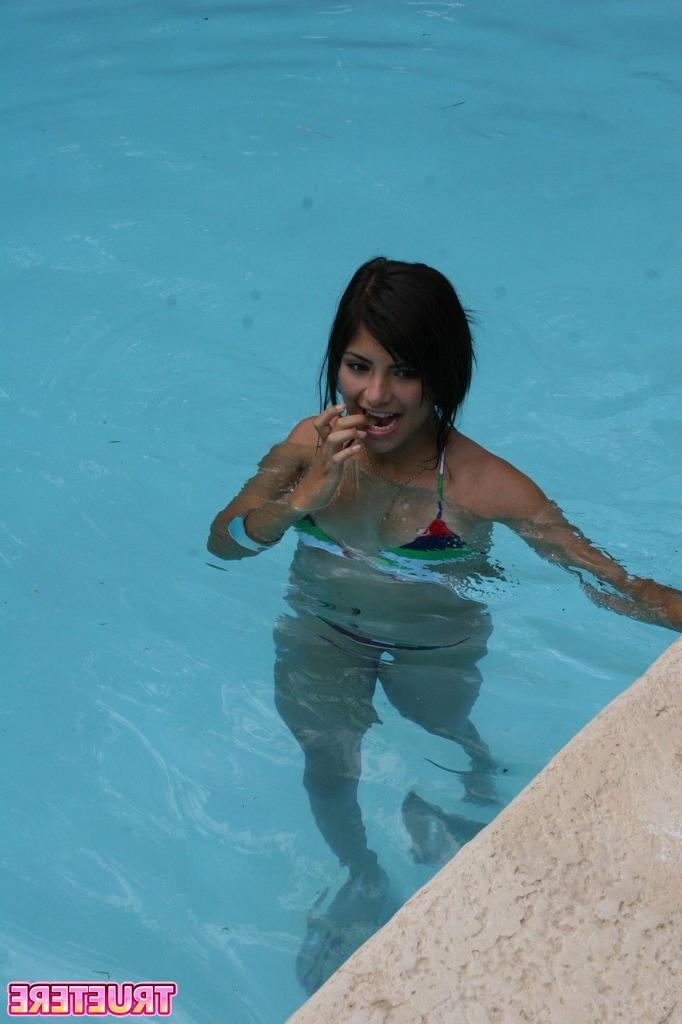 16P Bikini teen girl swimming in pool