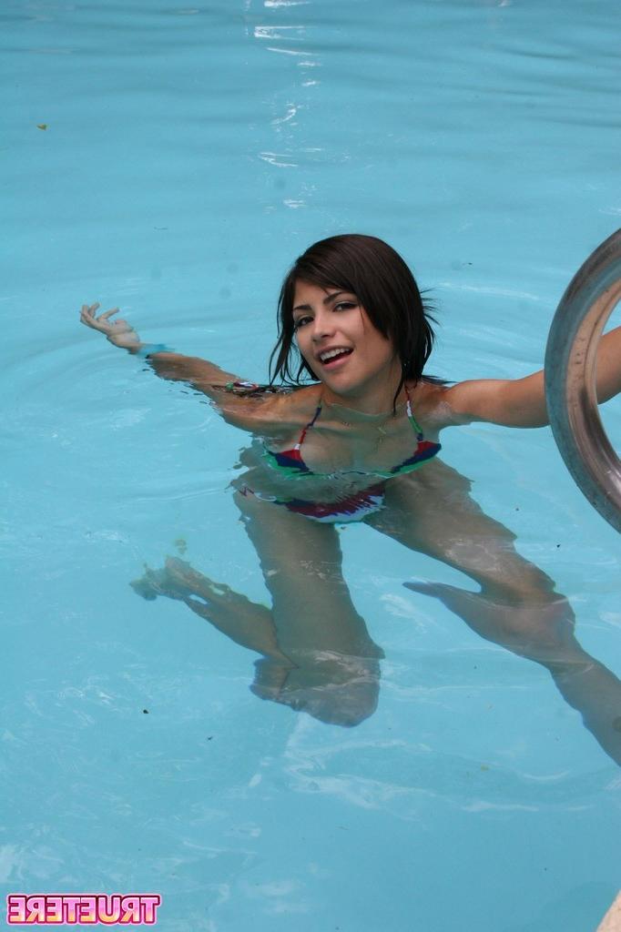 16P Bikini teen girl swimming in pool