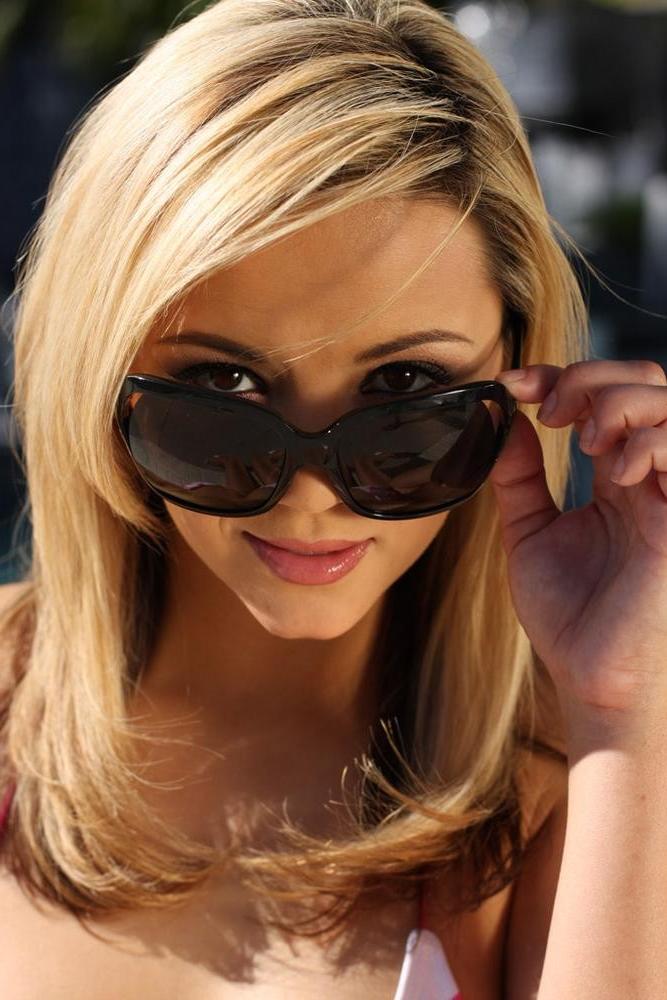 15P Ashlynn Brooke posing in a sexy pink bikini