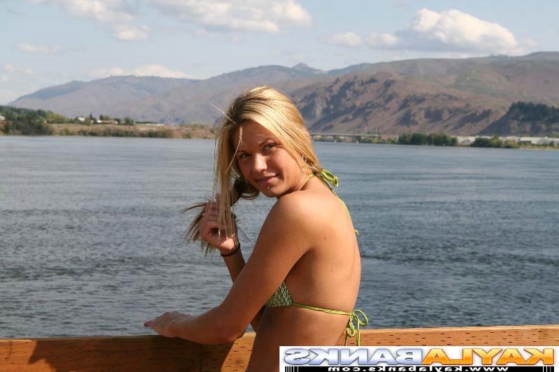 15P Naughty Kayla Banks posing at a lake in a green bikini