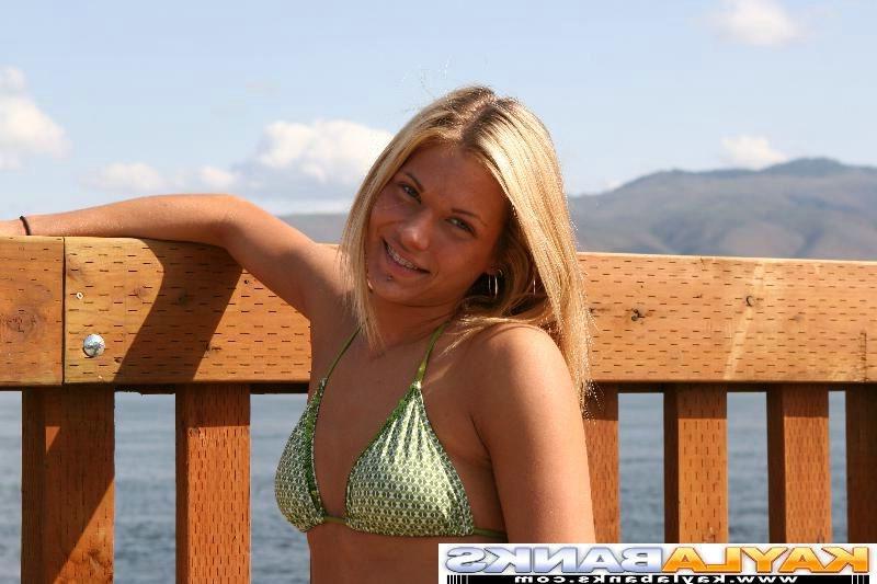 15P Naughty Kayla Banks posing at a lake in a green bikini