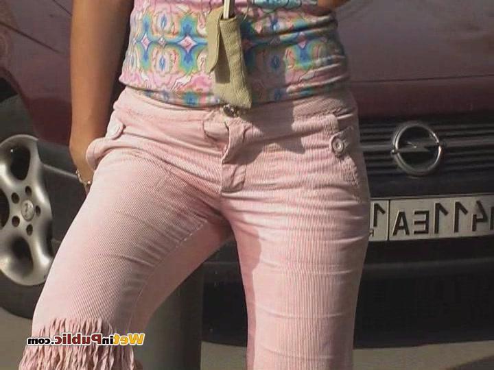 15P Curly blondie piddling in her sexy pink breeches right in the street