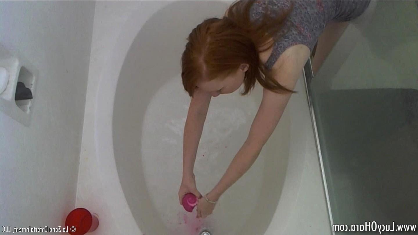 15P Busty redhead Lucy bathing